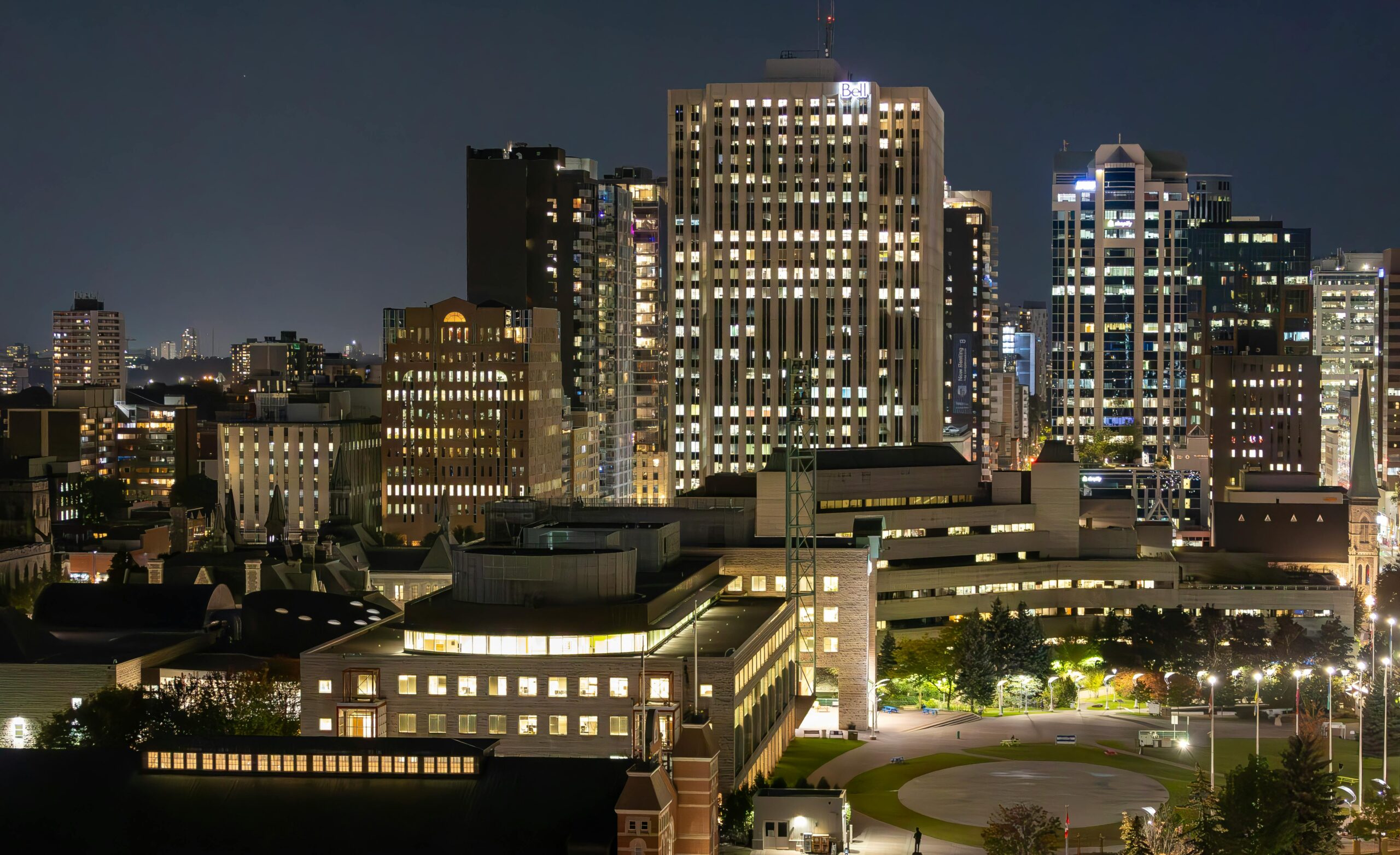 Beautiful view of Ottawa's illuminated skyline at night showcasing modern architecture.